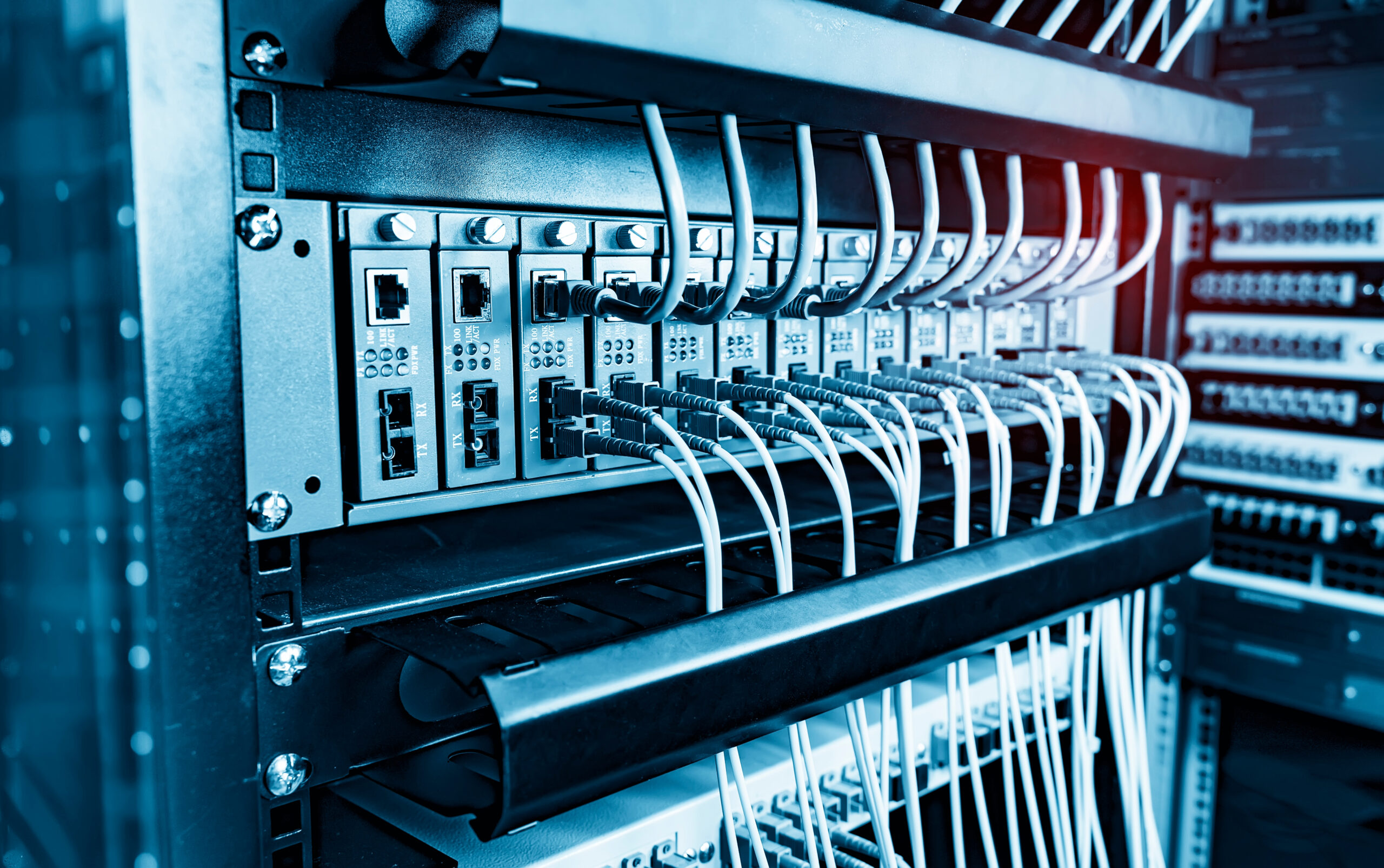 A data center aisle lined with illuminated server racks