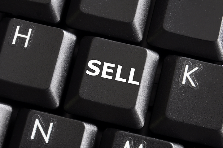 A computer keyboard with a blue key labeled SELL