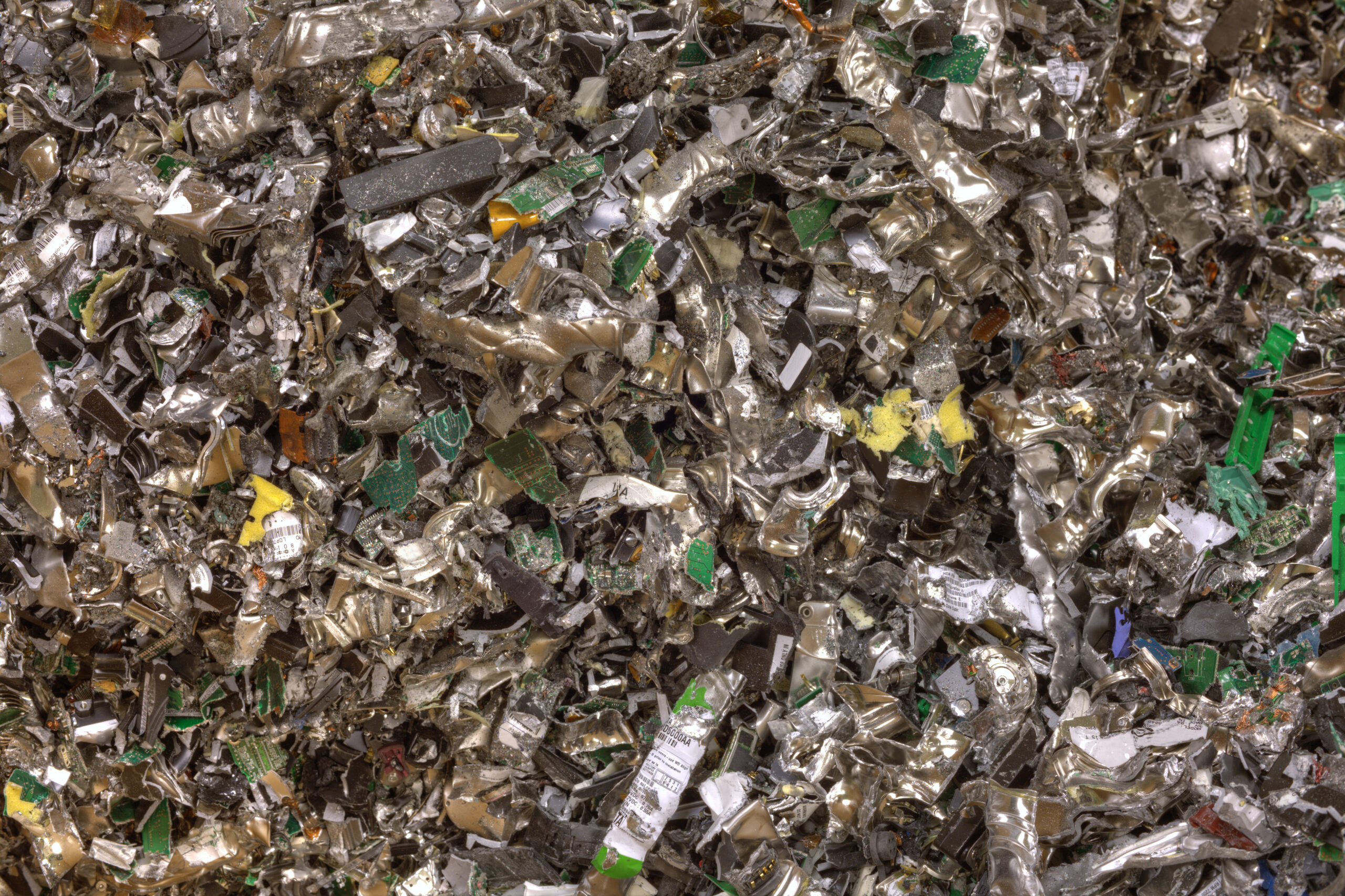 A pile of shredded electronic waste and circuit boards