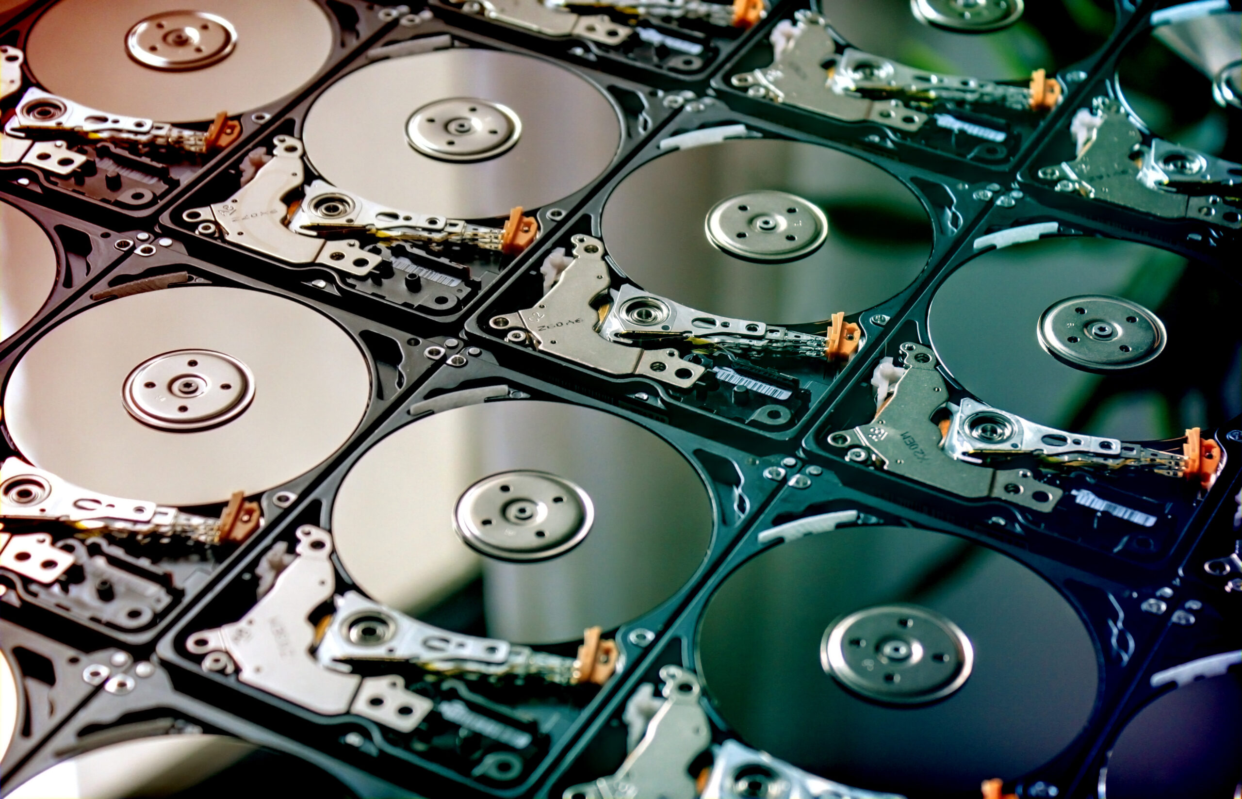 A close-up stack of hard disk drives with exposed circuitry
